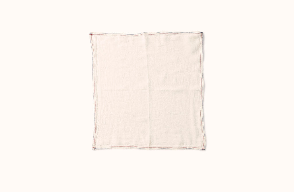 CHARVET BLUE AND RED EMBROIDERED STRIPE BORDER ON WHITE LINEN NAPKIN